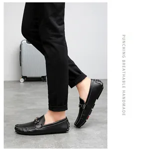 Detail view of men's black leather slip-on loafers with stylish white stitching