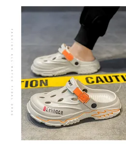 Detailed view of breathable white outdoor clogs featuring orange buckles and side lettering
