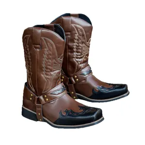 Western cowboy boots with brown leather, embroidery, and harness straps