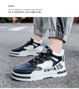 Stylish black and white mid-top lace-up sneakers shown on-foot in a street setting