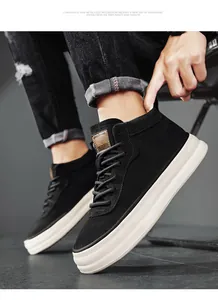 Macro detail of black suede mid-top board shoes featuring a thick white platform sole