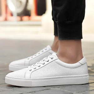 Men's white leather low-top casual sneakers with perforated breathable design and laces.