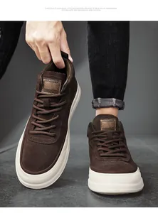 Detailed view of premium brown suede mid-top sneakers with thick soles and lace-up design