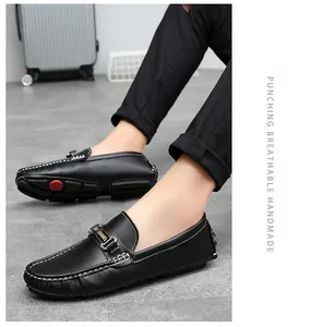 Side view of black leather driving loafers with decorative buckle and white stitching