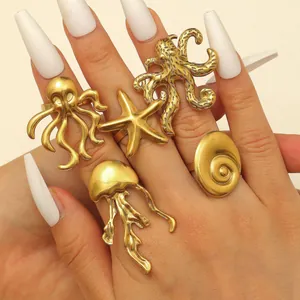 Detailed view of gold stainless steel ocean-themed rings featuring starfish and octopus designs