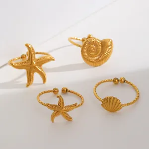 Macro detail of gold-plated stainless steel ocean starfish and seashell adjustable rings set