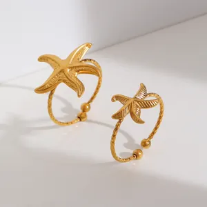 Detail of two gold stainless steel starfish adjustable open rings for women