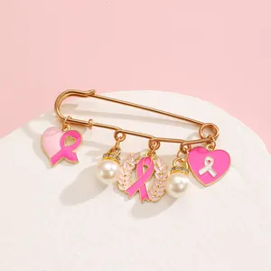 Elegant gold breast cancer awareness brooch with pink ribbon hearts and pearl charms