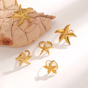 Detail view of various golden stainless steel starfish rings with textured finishes