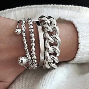 Set of 4 chunky silver-tone punk bracelets featuring a thick Cuban chain and beads