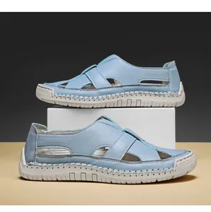 Side view of hand-stitched light blue breathable casual sandals on a display block