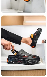 Detail of black men's beach clogs featuring orange accents and adjustable heel strap