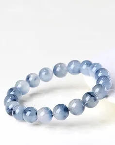 Detailed macro view of natural blue rabbit hair rutilated quartz bead bracelet