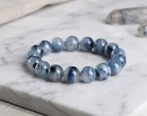 Detailed view of natural blue rutilated quartz crystal beads with fine rutile inclusions