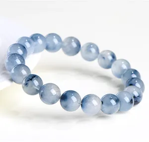 Close-up detail of natural blue rabbit hair rutilated quartz beads on a beaded bracelet