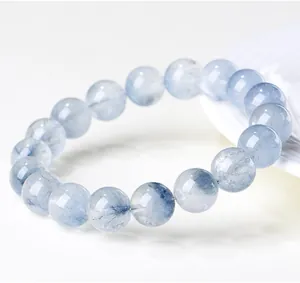 Macro view of natural blue rabbit hair quartz beads with unique hair-like inclusions.