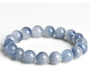 Macro view of blue rabbit hair quartz beaded bracelet showing natural rutile inclusions