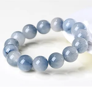 Close-up detail of natural blue rabbit hair rutilated quartz round bead bracelet jewelry