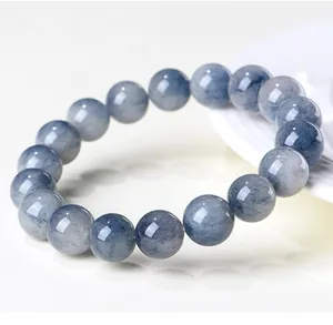Close-up detail of natural blue rutilated quartz beads bracelet with delicate hair-like inclusions