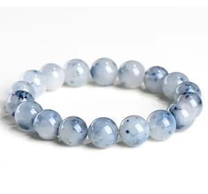Detailed view of natural blue rutilated quartz bracelet beads with needle-like inclusions