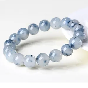 Macro view of natural blue rabbit hair quartz beads on a beaded bracelet