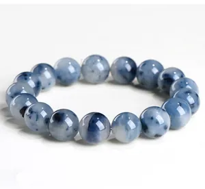 Detailed view of natural blue rabbit hair rutilated quartz round beads on a bracelet