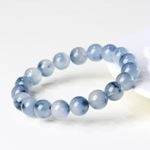 Natural Blue Rabbit Hair Rutilated Quartz beaded bracelet with polished translucent stones.