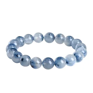 Natural blue rabbit hair rutilated quartz bead bracelet displayed on a pure white background.