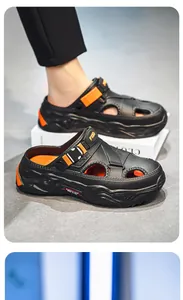 Side view of black men's sandals with thick soles and vibrant orange accents.