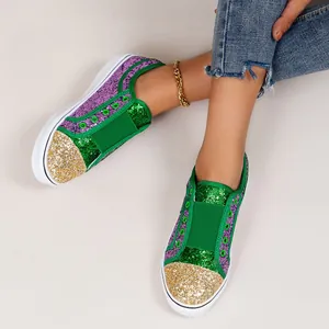 Detailed view of green purple and gold glitter sequins on women's slip-on sneakers