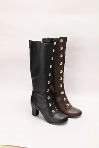Close-up of retro black and brown knee-high boots featuring stylish silver rivet details.