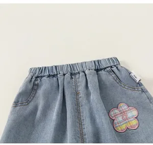 Vista detallada de pantalones vaqueros celestes para niños con cintura elástica y parche