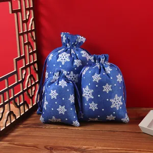 Detail of three blue snowflake drawstring bags in various sizes for Christmas gifting.