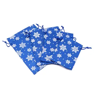 Detailed view of four different sized blue Christmas drawstring gift bags with snowflakes