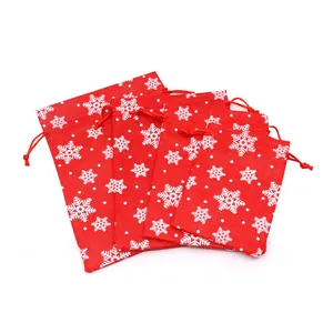 Detailed view of red Christmas drawstring linen bags featuring white snowflake patterns