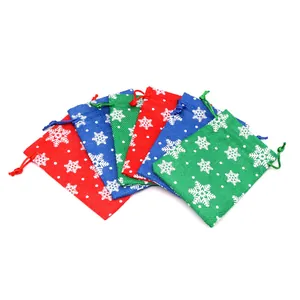 Colorful Christmas burlap gift bags with snowflake patterns and drawstring closures