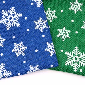 Macro view of blue and green imitation linen fabric with white snowflake pattern