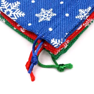 Close-up detail of Christmas snowflake burlap drawstring gift bags with vibrant textures