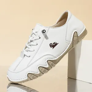 Detail view of white low-top casual leather shoes with wavy octopus rubber sole.