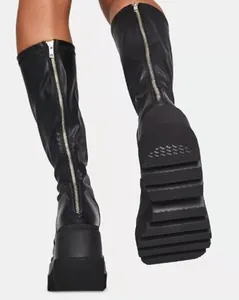 Detailed view of black platform knee-high boots featuring a full-length back zipper