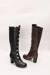 Detail view of vintage knee-high boots featuring rivet accents and chunky block heels