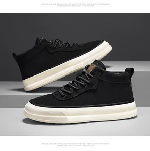 Macro view of black suede mid-top sneakers with a thick white platform sole design