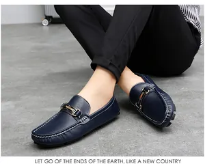 Detailed view of navy blue leather loafers for men featuring a gold metal buckle