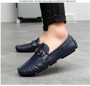 Detail of dark blue men's loafers with contrast stitching and metal buckle