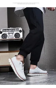 Vue détaillée de chaussures décontractées en fly-knit blanc avec détails en cuir brun