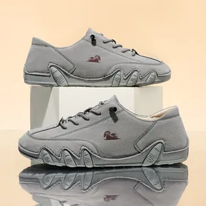 Detail of grey casual shoes with wavy octopus rubber sole and lace-up design