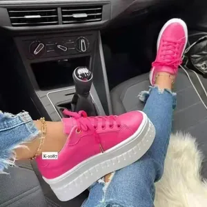 Vibrant pink lace-up platform sneakers with chunky white textured soles for women