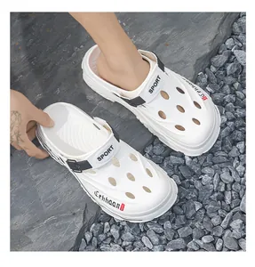 White breathable outdoor garden clogs for men displayed on a natural rocky surface