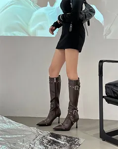 Vintage brown knee-high boots with studded buckle details and high heels for women.