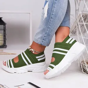Nahaufnahme von grün-weiß gestreiften Plateau-Stricksandalen mit offenem Zehendesign